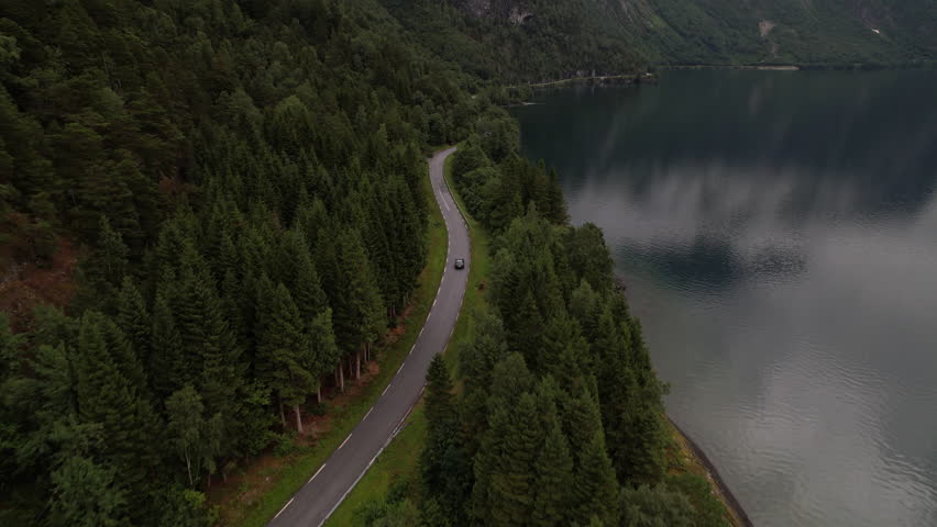Car Driving Along Lakeside Road Next to Eikesdalsvatnet Lake in Norway, Aerial View