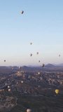 Air balloons flying over mountains in Cappadocia