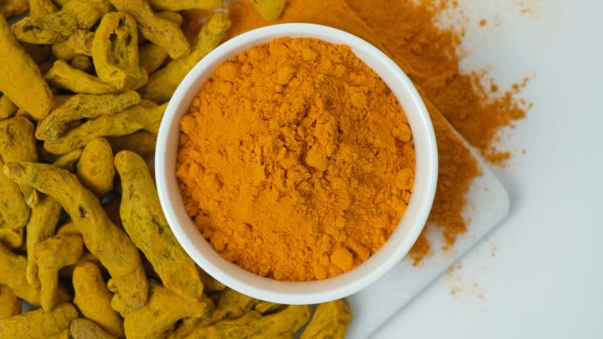 Dried turmeric root falling into powder top down slow motion Royalty-Free Stock Footage #3455520583