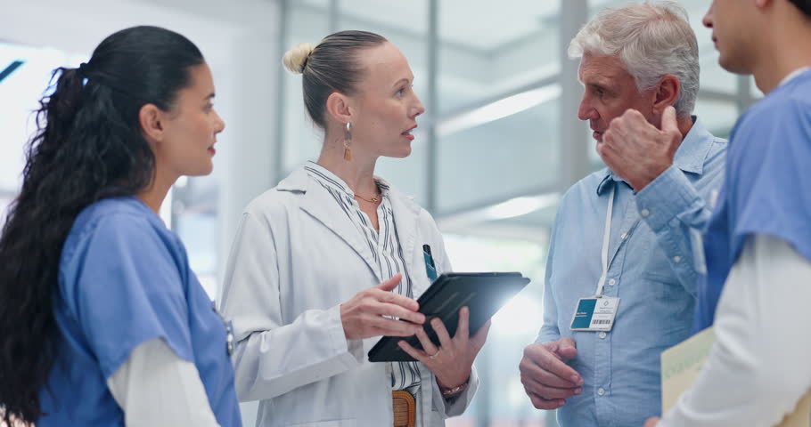 Tablet, discussion and group of doctors in hospital for collaboration on medical diagnosis. Conversation, career and team of professional healthcare workers with digital technology in medicare clinic Royalty-Free Stock Footage #3455534609