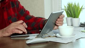 Close up senior mature man hands fingers typing using calculator, tablet screen. Elderly person calculating pension. Social media, connection with internet. Pensioner search information. Freelance - Powered by Shutterstock - Get 15% off with code: PIKWIZARD15