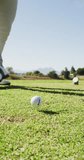 Vertical video of male golf player playing at golf course on sunny day. healthy and active time.