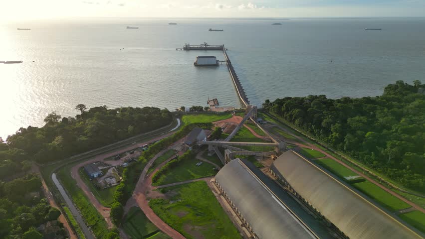 Aerial view of grain storage warehouses and private port facility in Itupanema village (Barcarena, PA, BR), hub for exporting soybeans and corn