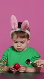 Vertical Video Ecstatic kids breaking a special easter egg to find a surprise inside, feeling curious about a festive decoration that transforms in a plant. Cheerful little children having fun in