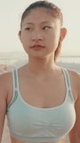 VERTICAL VIDEO, Close up, girl in sports top walking outside at morning time