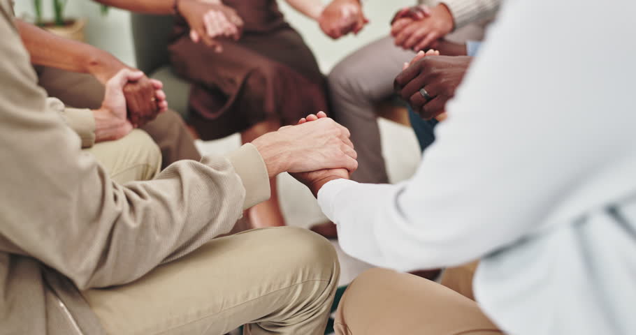 People, holding hands and together in group therapy with circle, praying or kindness for mental health. Men, women and empathy for compassion, help and psychology with trust, consulting or community