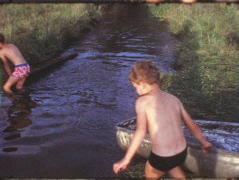 Vintage 8mm film: Children in bathtub on creek