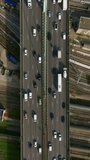 Cars are moving in heavy traffic on the bridge located in the capital of France. Rush hour traffic in the business district of Paris. Drone view of the urban set of cars. Vertical video
