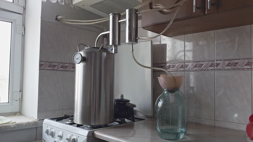 Domestic amateur distillation equipment for the distillation of moonshine alcohol, close-up with selective focus.
