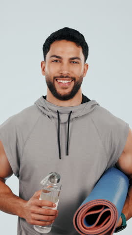 Man, face and yoga mat for exercise with water, hydration with fitness and health on white background. Wellness, workout and smile in portrait, bottle with h2o for thirst and pilates in studio