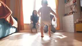 baby runs to his parents for first steps. happy family child - dream concept. little son takes his first steps towards his family at the window of the house. Cute baby learning to walk lifestyle - Powered by Shutterstock - Get 15% off with code: PIKWIZARD15