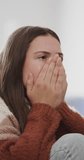 Vertical video of sad caucasian teenage girl crying in slow motion. Domestic life, lifestyle and despair.