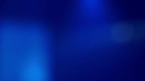 Abstract blurred background with colors in shades of blue, with moving lights flashing like those of a music concert. Real time video.