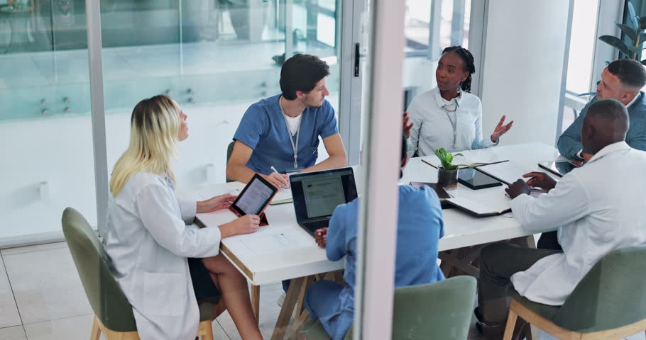 Medical, team and discussion for healthcare in conference room with technology, top view and meeting. Collaboration, doctor and nurse group in boardroom for surgery brainstorming and health planning