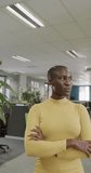 Vertical video of portrait of happy african american businesswoman in slow motion. Global business, finances and office concept.