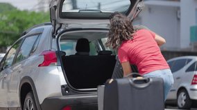 Happy couple puts his suitcase in the back of the car and prepares to leave for trip. Husband and wife open the back of the car put luggage travel. Couple moving into new home at moving day
 - Powered by Shutterstock - Get 15% off with code: PIKWIZARD15