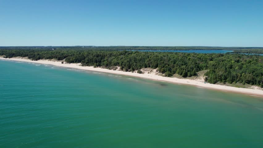 Drone aerial view of whitefish dunes state park shoreline on a windy day