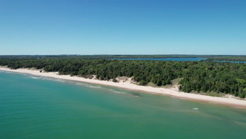 Whitefish dunes state park shoreline with white sand and waves crashing in