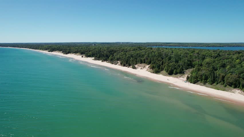 Drone shot flying to the left of whitefish dune state park shoreline