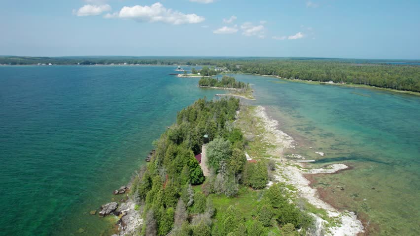 Drone aerial view of a light house on the shores of door county and lake Michigan