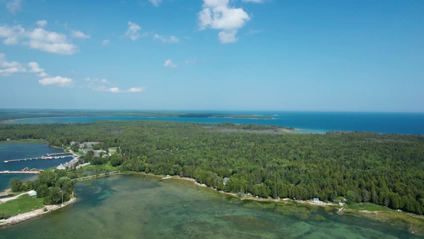 Drone view overlooking forest and shoreline of lake Michigan in door county