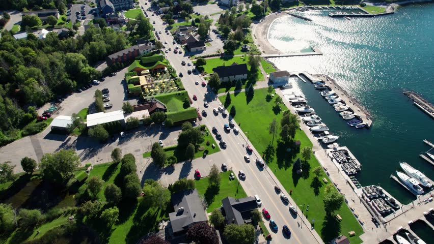 Panning drone shot of traffic through sister bay, wisconsin on a busy day