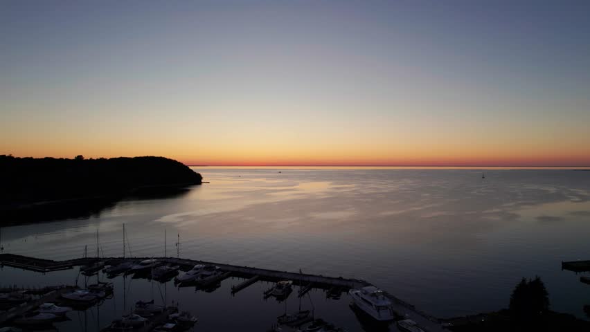 Panning to the left drone shot of sunset in Sister Bay, Wisconsin golden hour