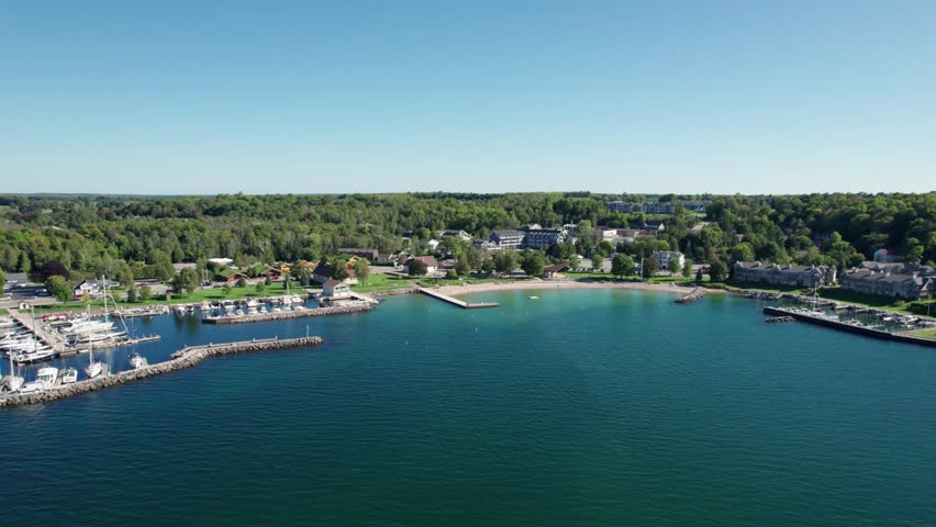 Distant drone shot of the turquoise colored water in sister bay, wisconsin