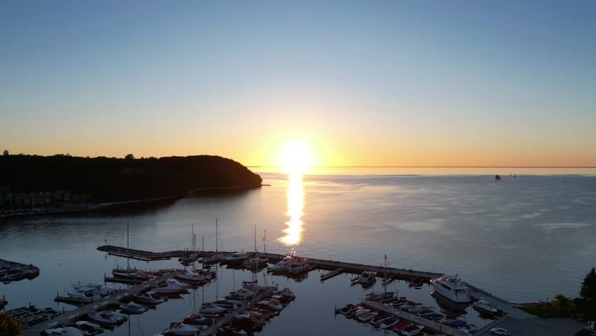 Timelapse drone shot of sister bay, wisconsin at golden hour in the fall with boats