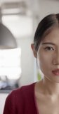 Vertical video of portrait of happy asian businesswoman smiling in office. Business, work and confidence.
