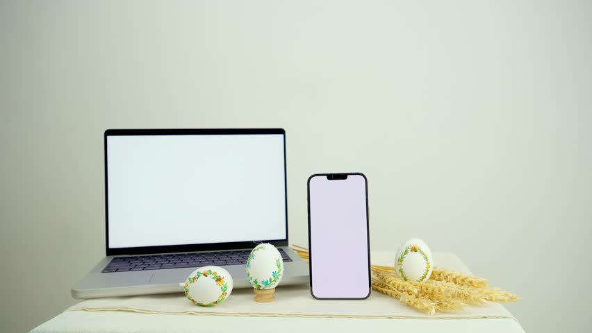 computer and mobile phone monitor with white screen empty space for advertising text next to easter eggs spikelets of wheat white background place for text holiday celebration easter Royalty-Free Stock Footage #3456248675