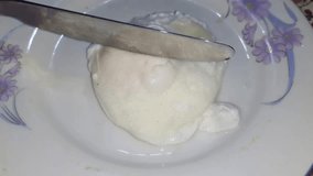 Video clips of poached egg cutting by dinner knife. 