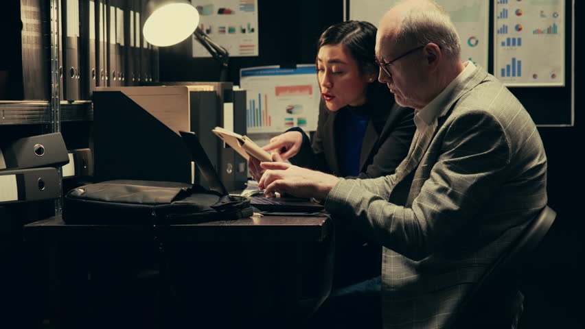 Investigators research backgrounds of suspects involved in archived old cases, looking for similarities to connect the dots. Team having forensic science expertise, uncover new case clues. Camera B.