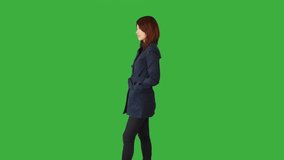 Green Screen of a Woman Standing with a Touchpad on her Hand