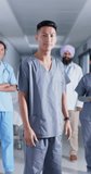 Vertical video of portrait of diverse doctors and nurses looking at camera, in slow motion. Hospital, medicine and healthcare.
