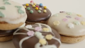 Shallow DOF sweets on white background close-up slow tilt 4K 2160p 30fps UltraHD footage - Pile of cookies with sprinkles  3840X2160 UHD tilting video