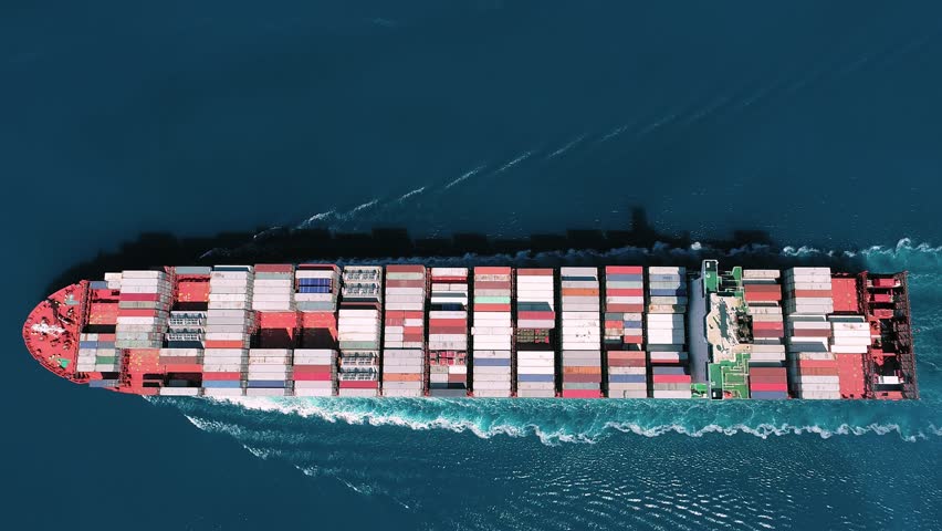 Cargo ship with containers stacked tidy row upon. Aerial top down view of a container ship. Her engine roaring at full speed, leaving wake water on open sea
 Royalty-Free Stock Footage #3456262331