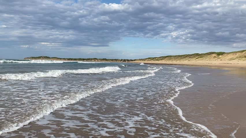 Video of shoreline of gentle rolling waves during hot weather at the beach in Torquay Melbourne 
Victoria Australia along Great ocean road.