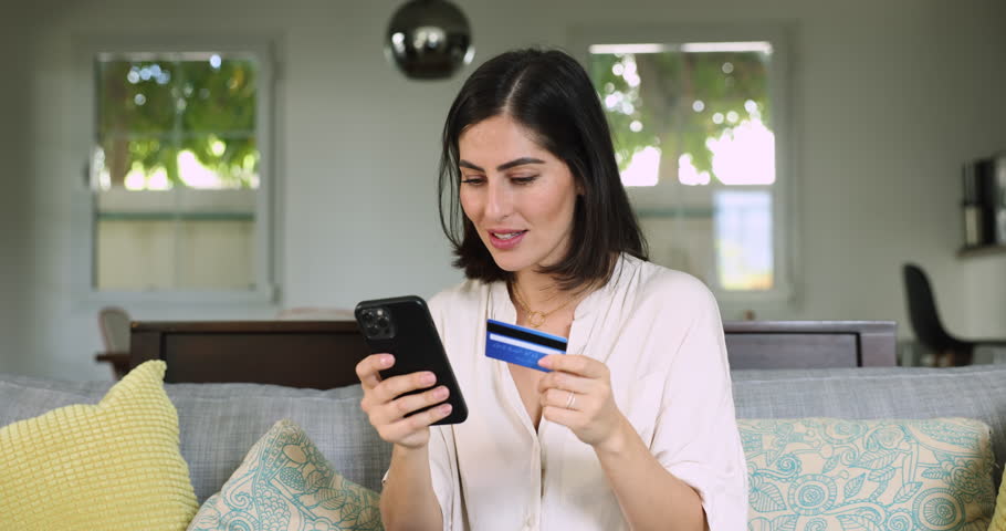 Young woman sit on sofa using card and smartphone feel stressed due to declined card during transaction, problems with network or internet connectivity while trying to make payment, insufficient funds Royalty-Free Stock Footage #3456288669