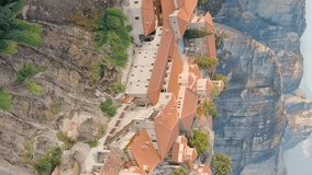 Vertical video. Meteora, Kalabaka, Greece. Monastery of the Transfiguration of the Saviour. Meteora - rocks, up to 600 meters high. There are 6 active Greek Orthodox monasteries listed on the UNESCO