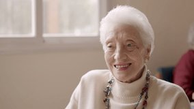 Old woman smiling at camera in a geriatric