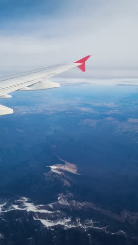 View from the plane window. Wing and sky in the window of the plane.