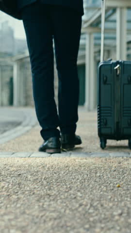 Business man, back and suitcase in street for travel, airport or immigration on walk, outdoor or trip. Person, luggage and shoes for steps on road, urban sidewalk or metro city for commute to hotel Royalty-Free Stock Footage #3456391893