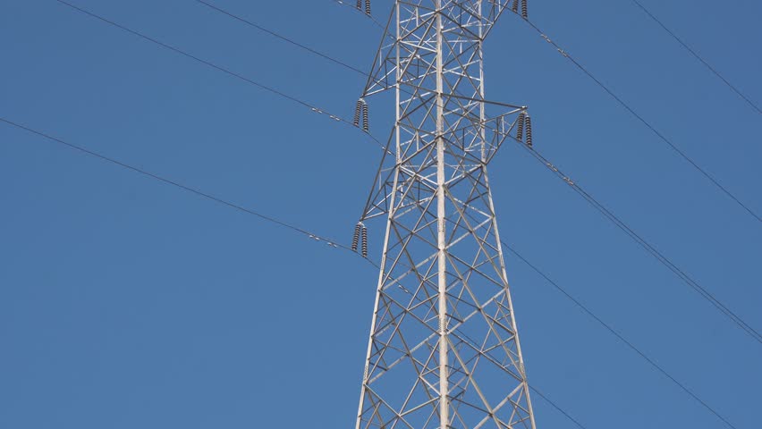 High voltage Electricity tower. Visualization of current in wires. High voltage tower concept. Electrical Transmission Tower against the blue sky. Prores of high voltage pole and moving clouds. 4K Royalty-Free Stock Footage #3456403141