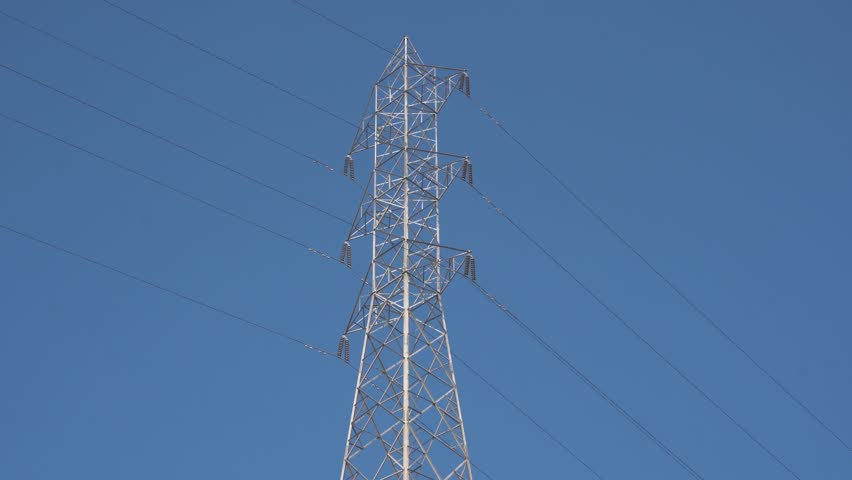 High voltage Electricity tower. Visualization of current in wires. High voltage tower concept. Electrical Transmission Tower against the blue sky. Prores of high voltage pole and moving clouds. 4K Royalty-Free Stock Footage #3456405103