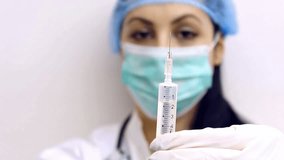 Flu vaccine ; Young doctor prepares an injection with the vaccine against influenza, video clip