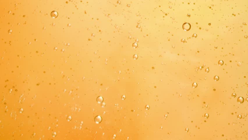 Abstract yellow colorful background with oil on water surface. Oil drops in water abstract psychedelic, abstract image.