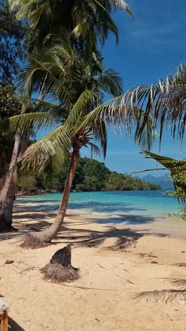 A picturesque tropical beach with palm trees, crystal clear water, and a beautiful natural landscape. The perfect destination for travelers seeking relaxation and tranquility Koh Wai, Island, Thailand