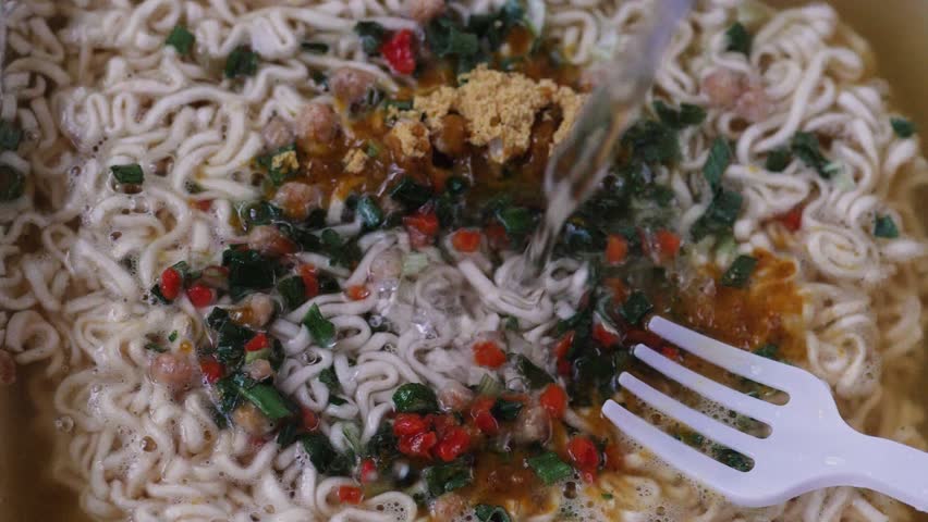Close-up, Adding water to instant noodles.Cooking instant noodles.slow motion.noodles quick cooking soup macro.Quick treat Royalty-Free Stock Footage #3456496147