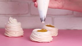 Chef cooking a Pavlova dessert, decorates cakes with cream. Close up food slowmotion video footage